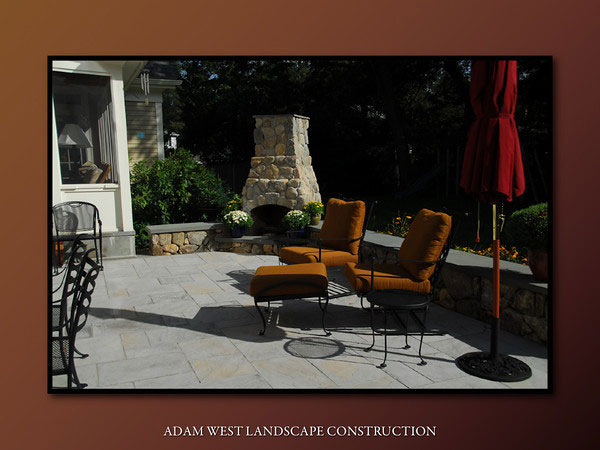 Patio with stone wall and fireplace